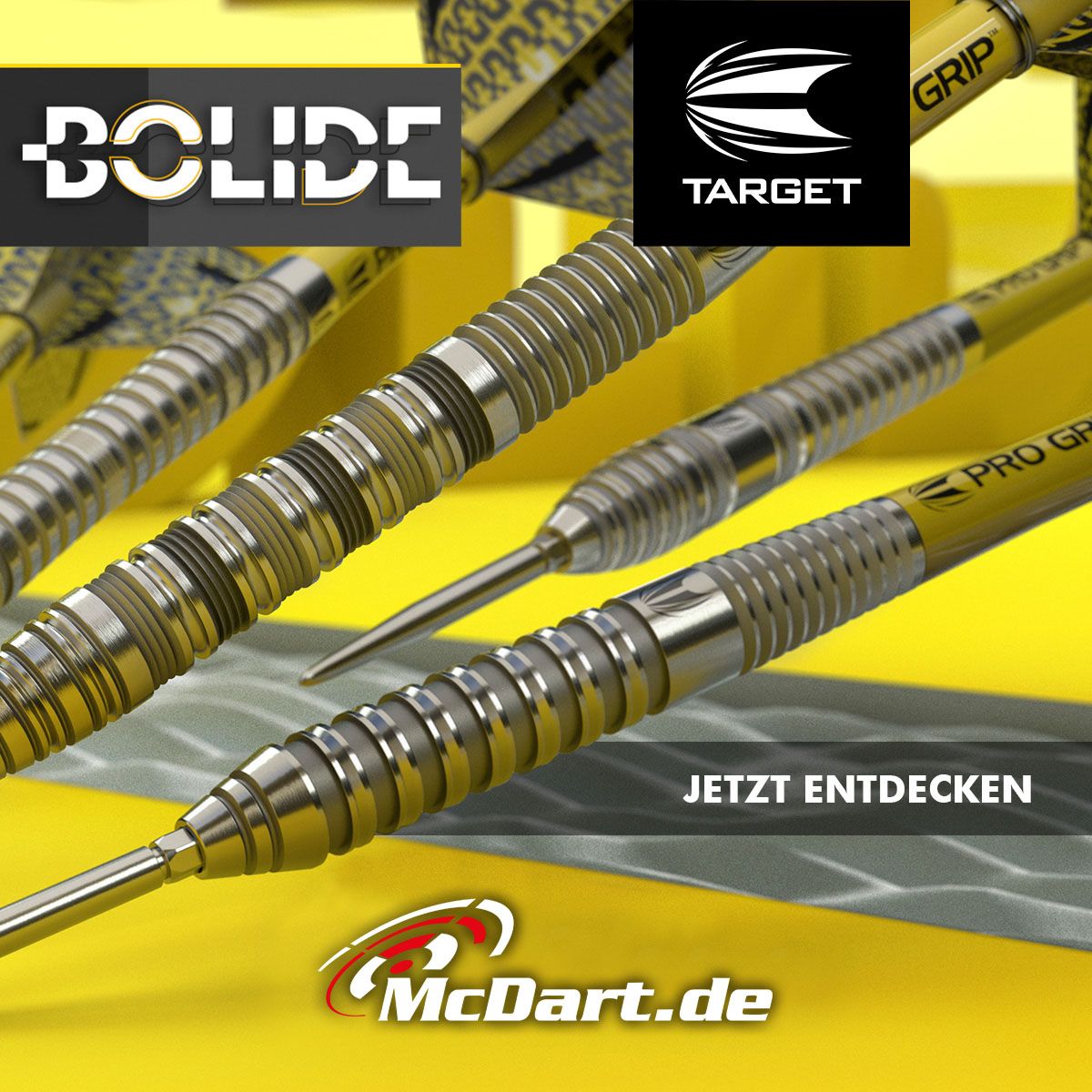 190051_Target_Bolide_Swiss_Point_Steeldarts_admedia Das Bild zeigt die Target Bolide 01 Swiss Point Steeldarts mit silbernem und gelbem Design. Im Vordergrund steht die Aufforderung "JETZT ENTDECKEN" sowie das Logo von McDart.de.
