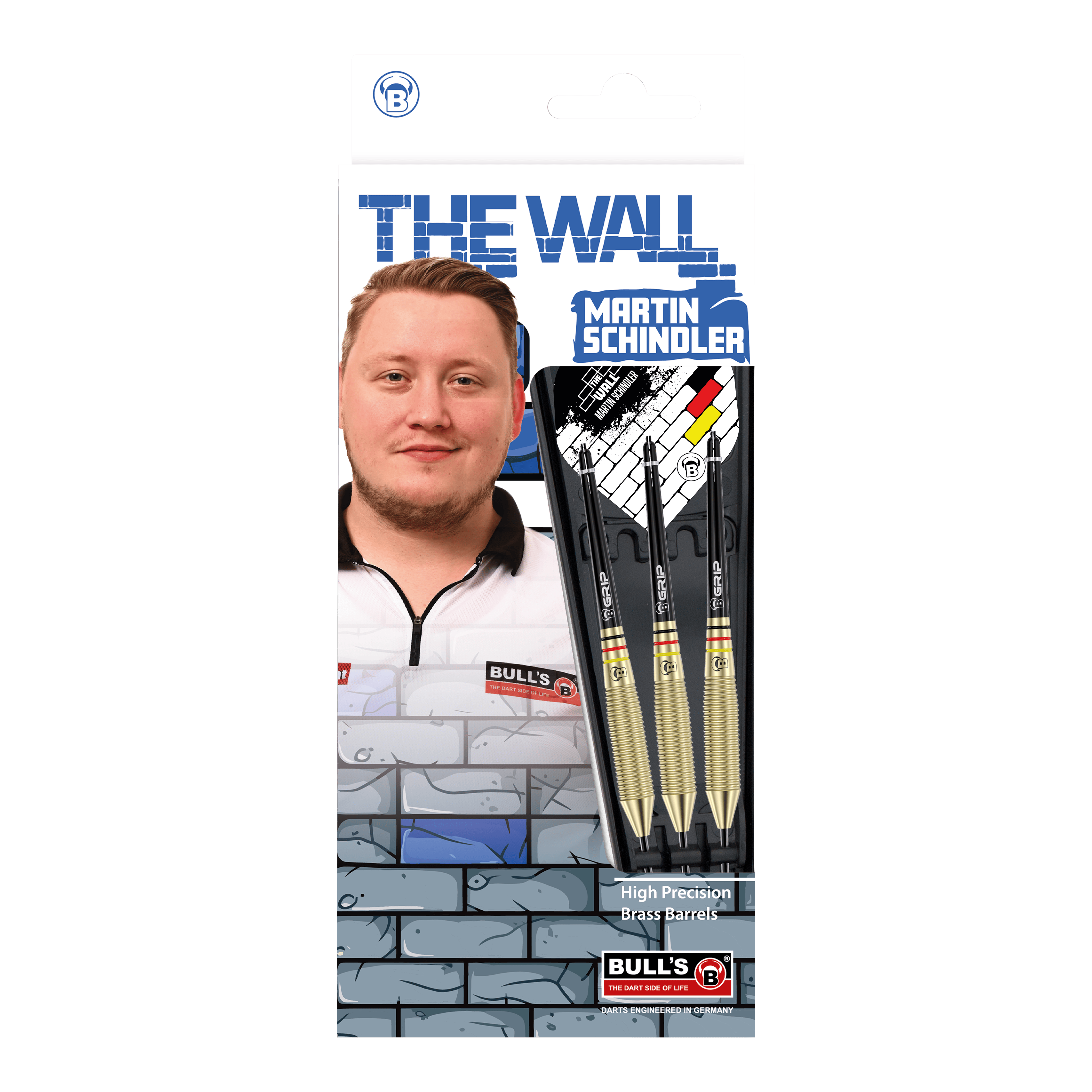 Auf dem Bild ist die Verpackung der "Bulls Martin Schindler The Wall Brass Steeldarts" zu sehen. Sie zeigt ein Foto von Martin Schindler sowie drei Steeldarts mit Messing-Barrels.