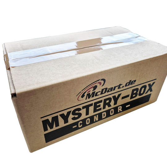 McDart Condor Mystery Box Auf dem Bild ist ein brauner Karton mit der Aufschrift "McDart.de Mystery-Box Condor" zu sehen. Der Karton ist mit Klebeband versiegelt.