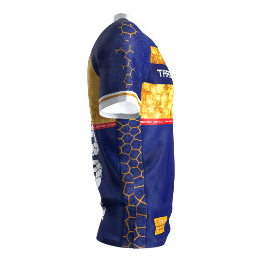 Target Coolplay Josh Rock Dart Shirt 2025 Das Bild zeigt das Produkt "Target Coolplay Josh Rock Dartshirt 2025". Das Shirt ist überwiegend blau mit goldenen und weißen Mustern sowie auffälligen grafischen Elementen gestaltet.