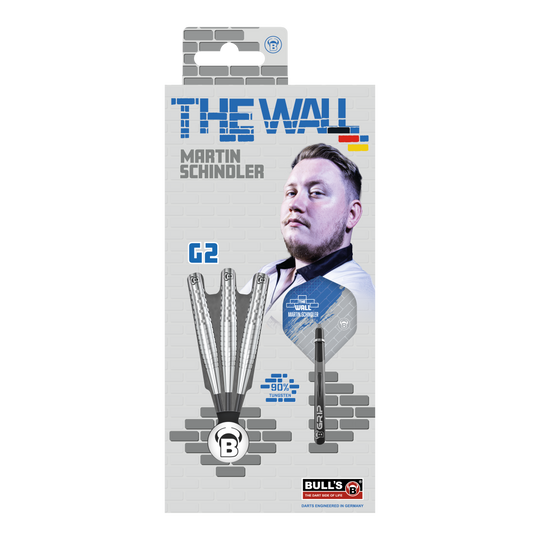 Bulls Martin Schindler Original Generation 2 steel darts Die Verpackung zeigt die "Bulls Martin Schindler Original Generation 2 Steeldarts" mit dem Bild von Martin Schindler. Auf der Vorderseite sind drei Darts und die Aufschrift "THE WALL" sowie "90% Tungsten" abgebildet.