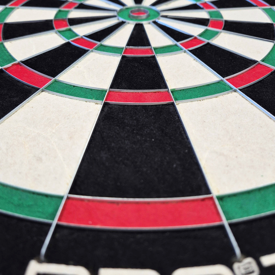 Harrows Quadro 240 steel dartboard Das Bild zeigt eine Nahaufnahme des Harrows Quadro 240 Steeldartboards. Die Farbfelder in Schwarz, Weiß, Rot und Grün sind deutlich zu erkennen.